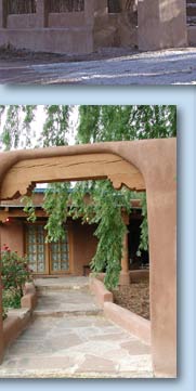 Photo of archway with willow tree and building beyond it