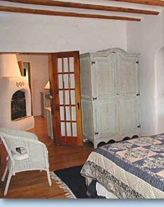 Photo of bedroom and partial view of living room